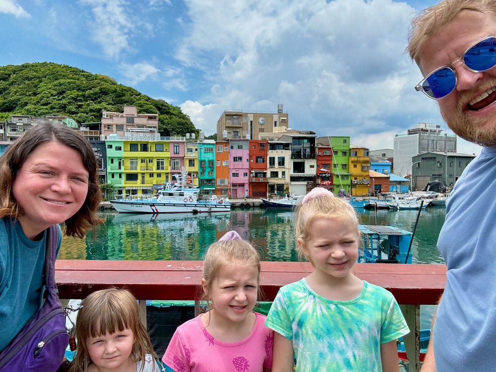 The whole Clarkson family in a selfie at the colorful painted Zhengbin fishing village near Keelung, Taiwan, on a sunny day